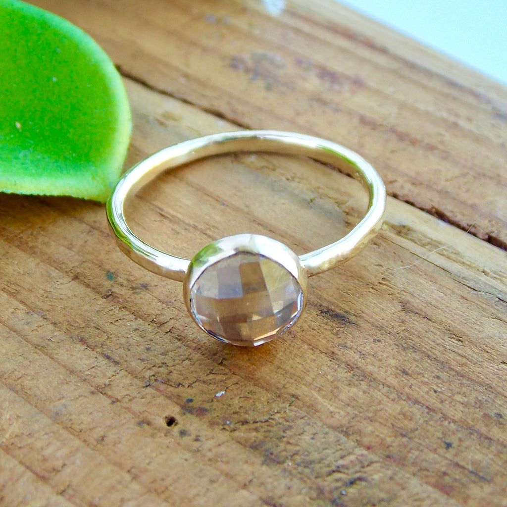 Unique solid gold wedding ring with a rose cut white topaz stone that sparkles. Band has a hammered texture made in yellow, rose, or white gold. Engagement ring that can be stacked with a wedding band.